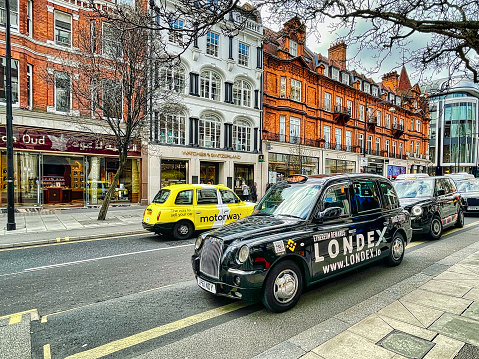 London, United Kingdom - March 07 2022: a typical black taxi cab on a street in the british capital