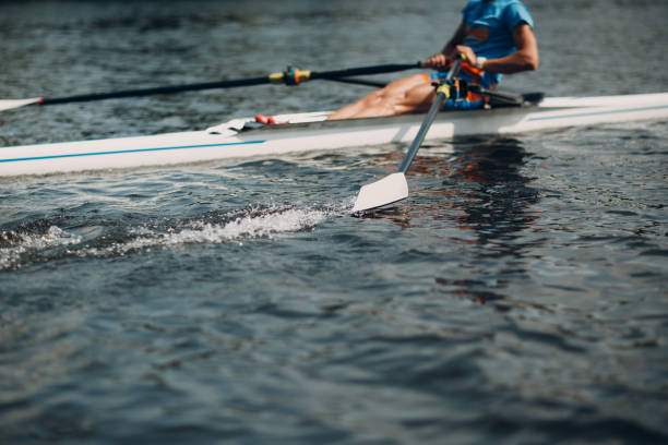 Sportsman single scull man rower rowing on boat stock photo