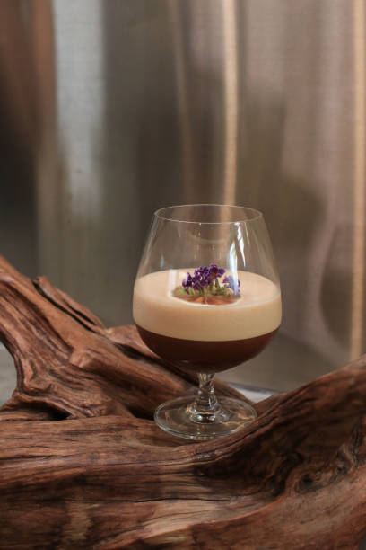 istock Espresso mocktail based on coffee and juice on wood background. Creative new exotic cocktail drinks a combination of cold brew coffee with juice. 1409787116