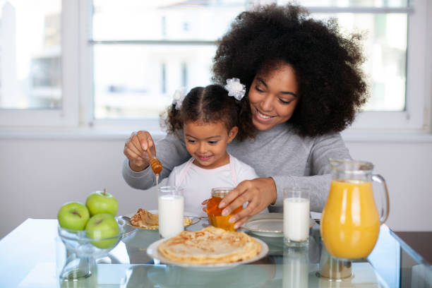 istock African-American young mother and daughter having breakfast 1409790718