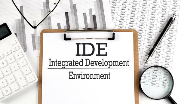 istock Paper with IDE INTEGRATED DEVELOPMENT ENVIRONMENT a table on charts, business concept 1409792762