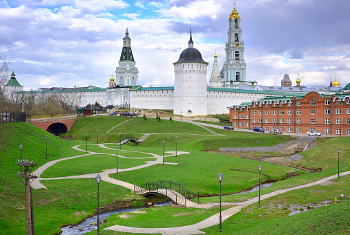 Ivan the Great Bell Tower, with Assumption Belfry on the right on a sunny day with blue sky. Blue sky background with sunbeams. Moscow Kremlin, Russia