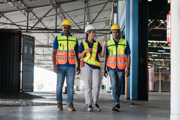 istock Manager and supervisor taking inventory in warehouse, Foreperson making plans with warehousemen, Workers team working in warehouse 1409796694