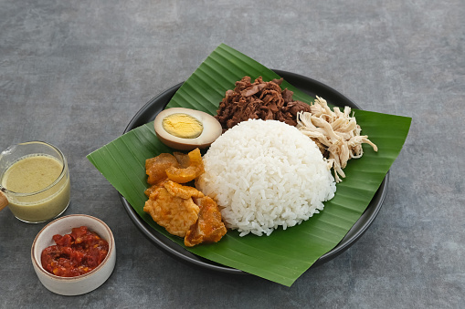 Gudeg, a typical food from Yogyakarta, Indonesia, made from young jackfruit cooked with coconut milk. Served with spicy stew of cattle skin crackers, brown eggs, shredded chicken and sambal.