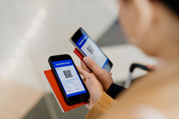 istock Business travellers using smartphone for electronic boarding pass on mobile app 1409799239