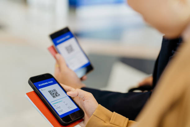 istock Business travellers using smartphone for electronic boarding pass on mobile app 1409799288