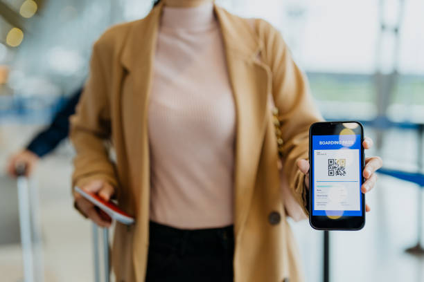 istock Female traveller showing boarding pass on smartphone 1409799293