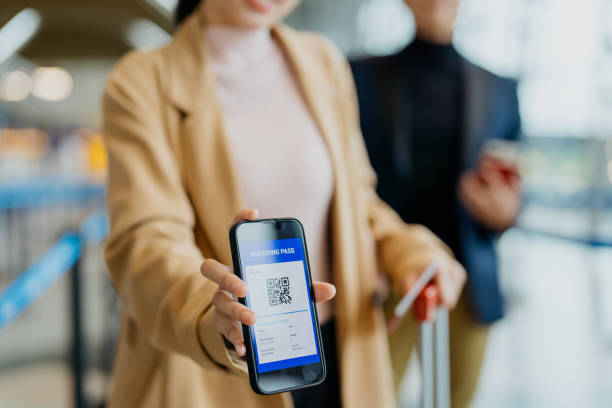 istock Female traveller showing boarding pass on smartphone 1409799295