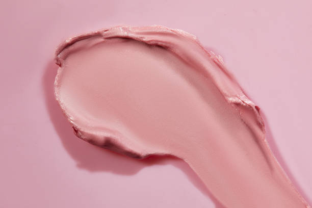 istock Pink, peach and red lipstick swatch on white background with copy space. Lipgloss swipe texture, 1409800617