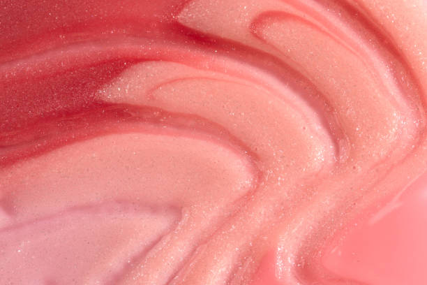 istock Pink, peach and red lipstick swatch on white background with copy space. Lipgloss swipe texture, 1409800635