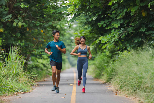 istock Asian couple, they are jogging and exercising. 1409803560