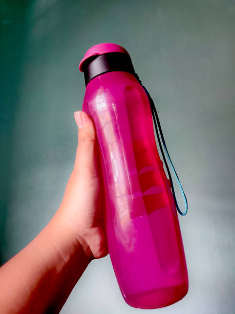 Holding a drinking  pink water bottle