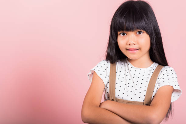 istock Asian little kid 10 years old smiling with arms crossed 1409803829