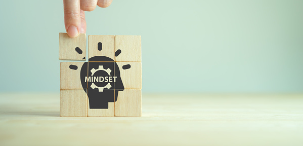 Business mindset and success concept. Growth and personal development. Believing in yourself matters. New mindset new results. Placing wooden cubes with changing mindset icon on smart background.