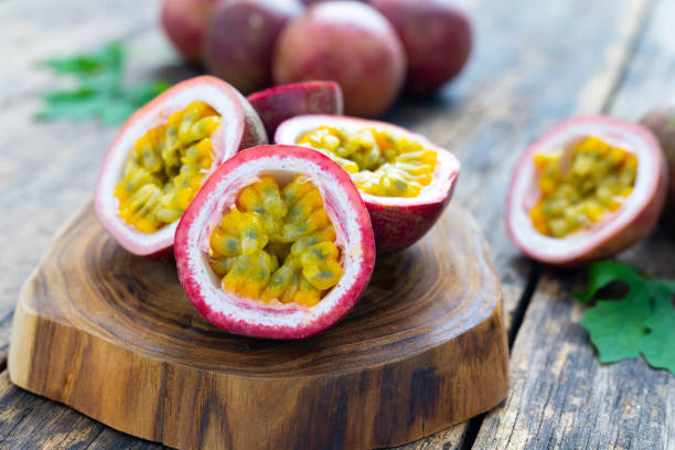 istock Passion fruit ( Maracuya ) with Passion fruit cut in half slice on wooden table background . 1409808377