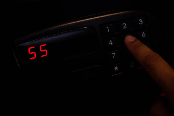 istock Hand press key on black safety box with a number 1409808483