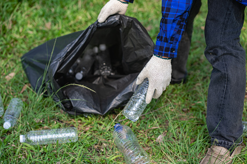 volunteers collect plastic bottles in garbage bags ecology natural pollution garbage care charity volunteer community environment young sincerity Recycling that can be sold as family income