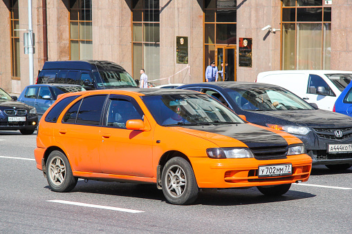 Moscow, Russia - June 2, 2013: Bright urban hatchback Nissan Almera (N15) in the city street.
