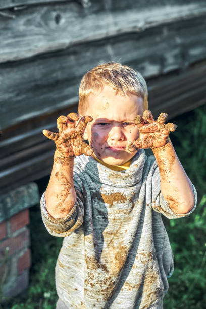 istock Angry boy gets dirty after playing in the sandbox 1409815559