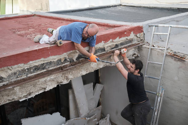 istock Two handymen removing old metal beams in a construction house. 1409820367