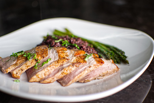 Sous vide pork tenderloin with black rice risotto and haricot verts.