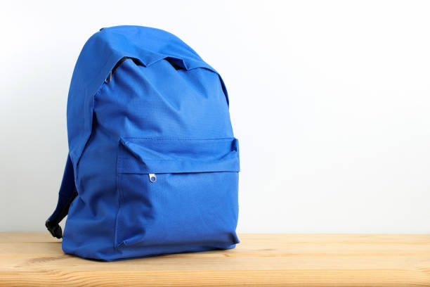istock Blue school backpack, sports bag on the table. 1409821174