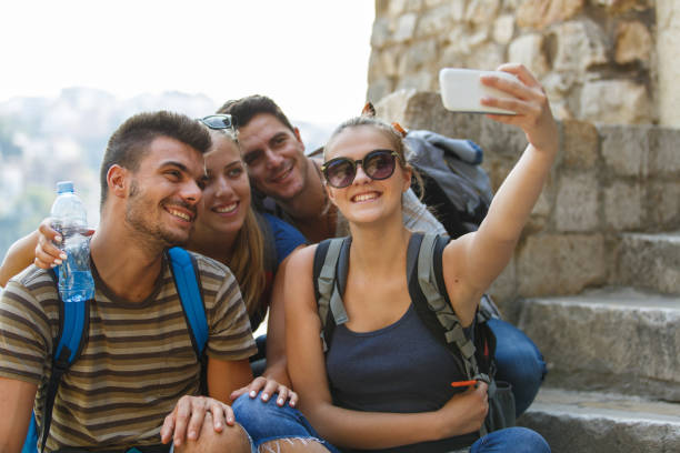 istock Group of four friends taking selfies together while taking a break from hiking 1409822500