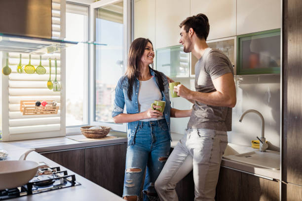istock Happy couple talking during coffee time in the kitchen. 1409822544
