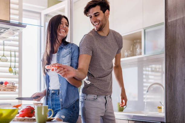 istock Young couple preparing food in the kitchen. 1409823229