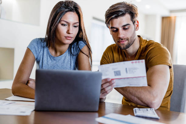 istock Young couple paying their bill over laptop at home. 1409823330