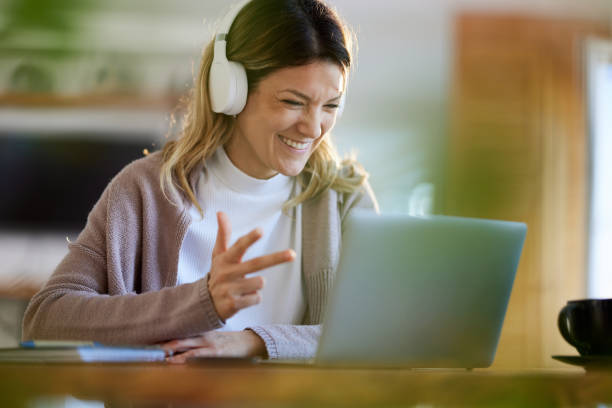 istock Happy woman having a video call at home office. 1409823605
