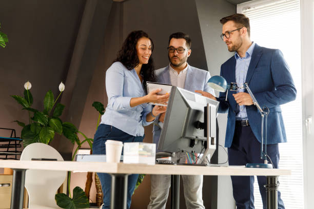 istock Three business colleagues reviewing project notes and engaging in casual discussion 1409823943