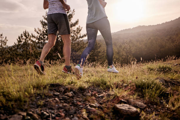 istock Unrecognizable couple jogging on a hill in nature. 1409824759