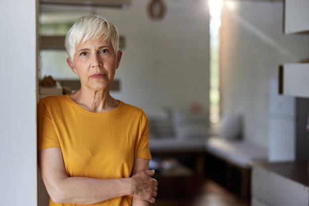Senior woman day dreaming at home.