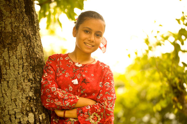 Rural girl looking at camera outdoors in nature