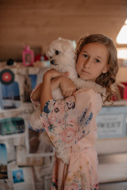 istock A child with a dog in her arms. 1409825036