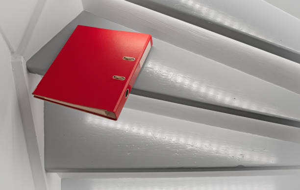 istock Red file on the stairs, selective focus 1409825735