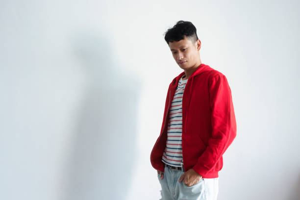 brunette asian in red jacket for vision poses on a white background.