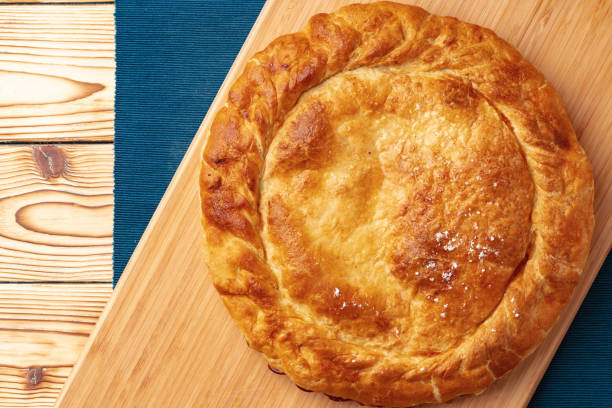 istock Apple pie on a wooden board close up 1409827347