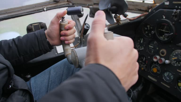 Male hands of the pilot take the steering wheel of the plane.