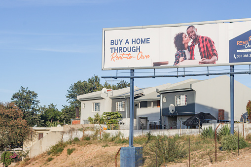 A billboard advert depicting the Rent-To-Own Programme in Windhoek at Khomas Region, Namibia. This service allows young people to become entry level homeowners.