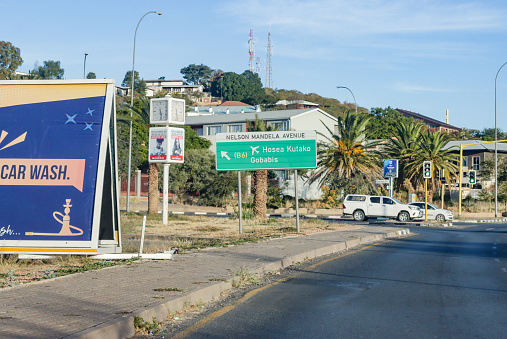 Nelson Mandela Avenue in Windhoek at Khomas Region, Namibia, with cars and commercial signs visible.