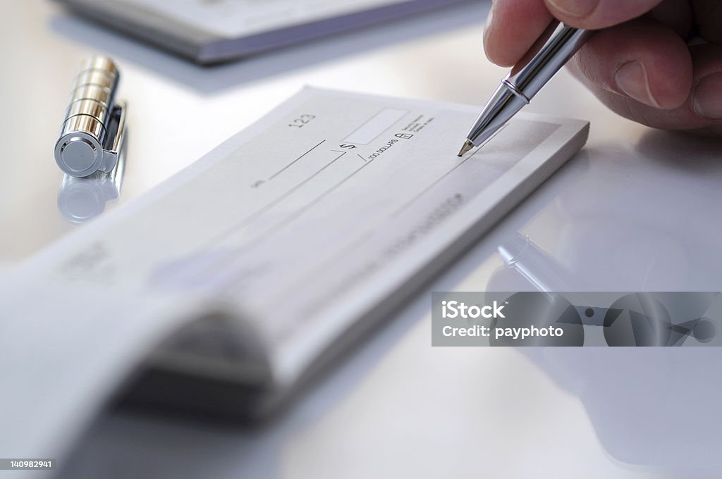 Prepare writing check Businessman prepare writing check in the office Check - Financial Item Stock Photo