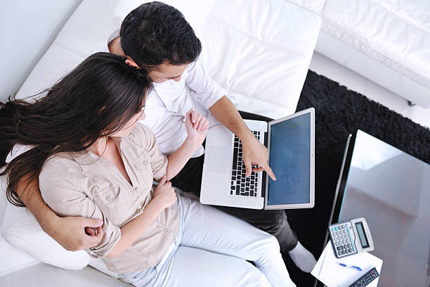 istock couple relax and work on laptop computer at modern home 140983070