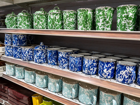 Three rows of displayed coffee mugs with Indonesian traditional retro textures and dominant colors of green, navy blue, and mint blue.