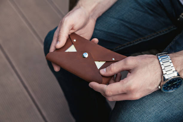 istock A man holds a leather wallet with credit cards in his hands 1409831568