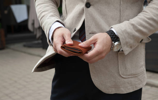 istock A business man is holding a brown leather wallet 1409831569