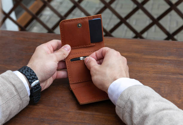 istock A business man is holding a brown leather wallet 1409831571