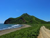 View of the mountain and the coast in Tikhaya Bukhta, located on the east coast of Sakhalin Island, Russia