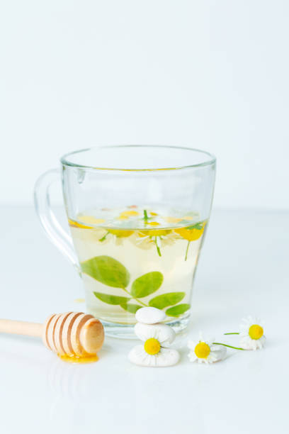 chamomile tea and honey, healing and summer. the concept of meadow summer herbs and fresh healing honey. cosmetology concept stock photo
